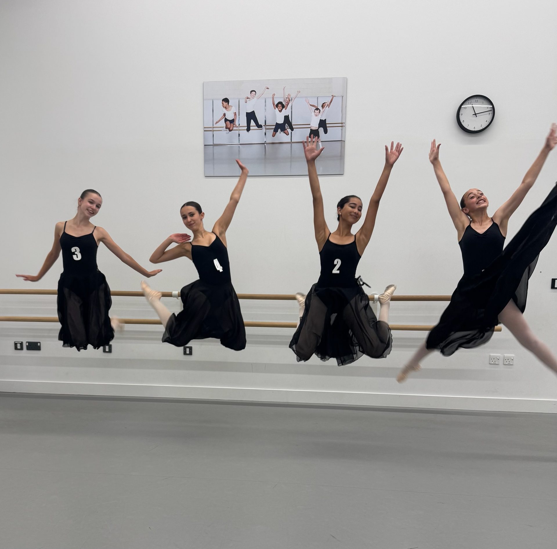 Students jumping together during a dance class in Wimbledon